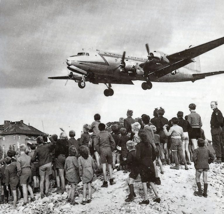 Berliners watch as a C-54 arrives in Berlin in 1948.