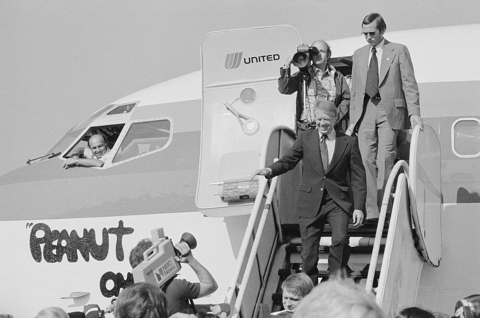 Jimmy Carter greets press as he steps off of Peanut One, a Boeing 727 during the 1977 campaign.