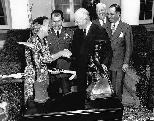 How Jackie Cochran and the Lockheed JetStar Made Aviation History in 1961 2 Jackie Cochran and Chuck Yeager being presented with the Harmon International Trophies by President Dwight Eisenhower