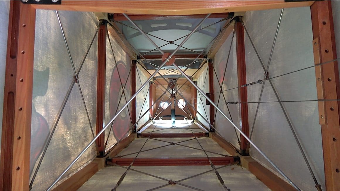 This view from the observer/gunners cockpit shows the internal framing and bracing in the rear fuselage of the aircraft. From a distance is easy to think of a linen covered aircraft to be quite solid, but this image highlights that these aircraft really were just made up of wood, wire and ‘canvas’. Photo Copyright © Historical Aviation Film Unit.
