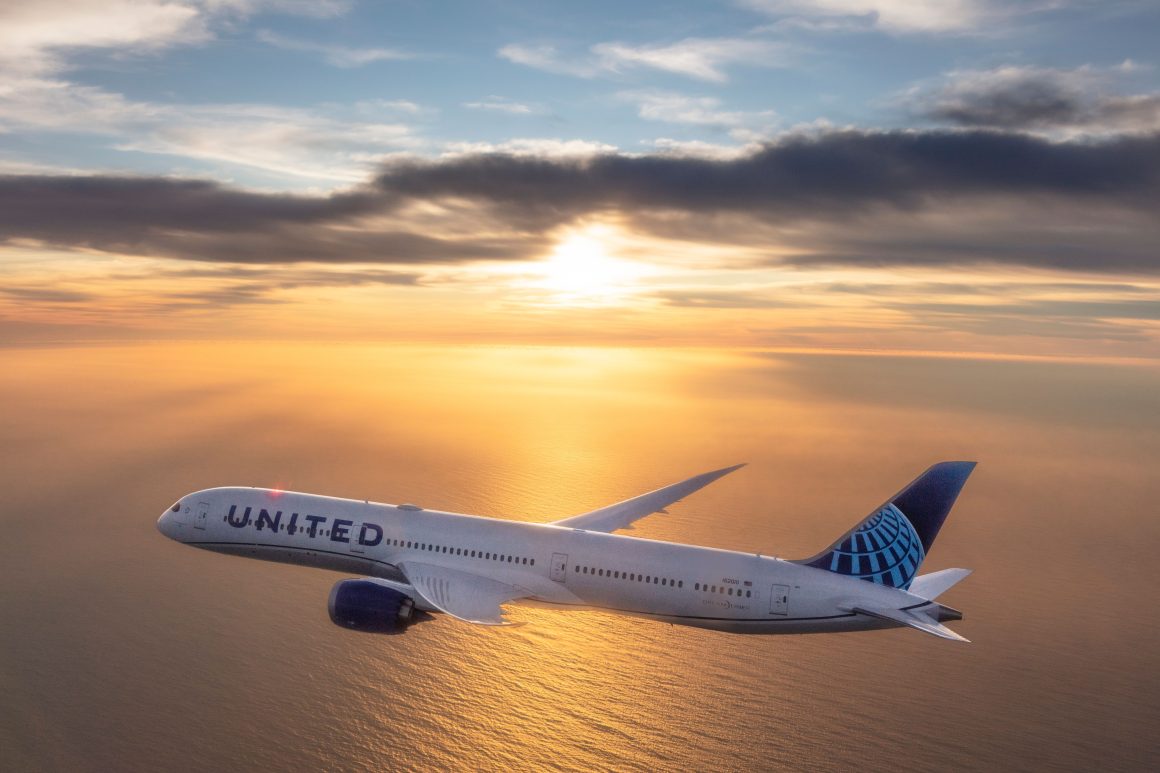 A United Airlines Boeing 787 flies over water