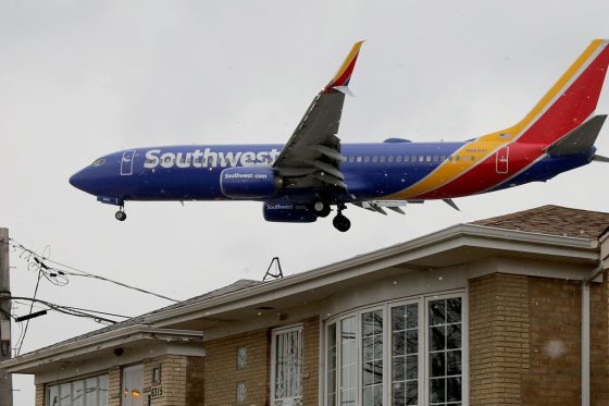 A Southwest 737 on approach over a neighborhood at Midway Airport. What's the biggest plane to land at Midway? Hint: It's not a 737.