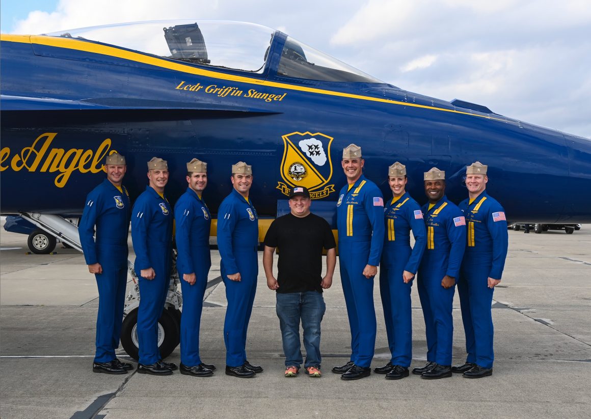 Kyle stands with the Blue Angels team.