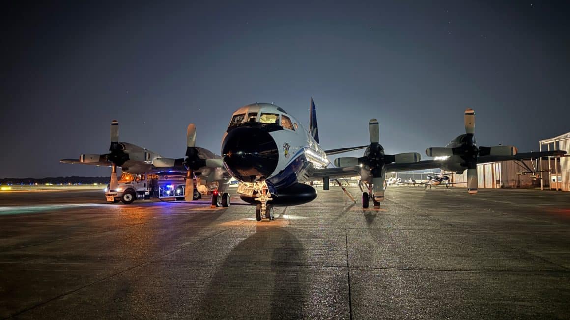 The P-3 Orion sits on the ramp at night