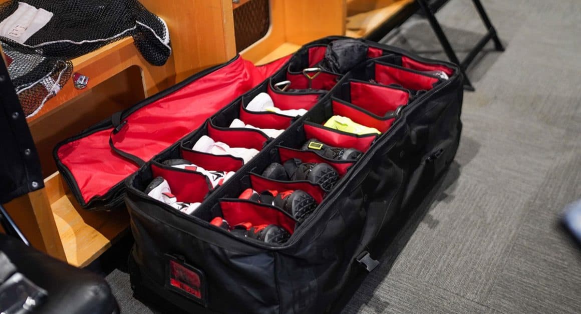 Shoes packed for NBA team prior to away game is an example of NFL and NBA team travel needs. 
