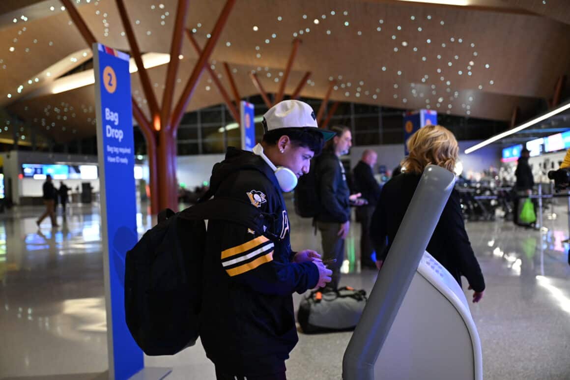 A passenger checks in for a flight at Pittsburgh Airport's new terminal