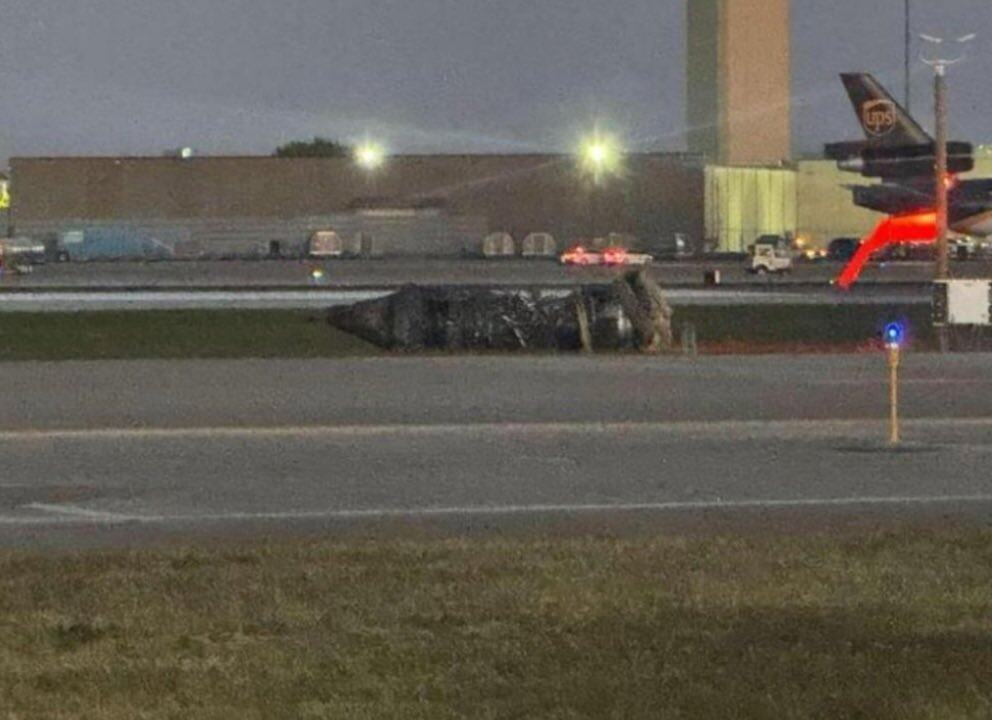 UPS MD-11 Crashes Shortly After Takeoff in Louisville, Death Toll Rises to 7 4 Image of an engine to the side of the runway at SDF after the crash of UPS Flight 2976
