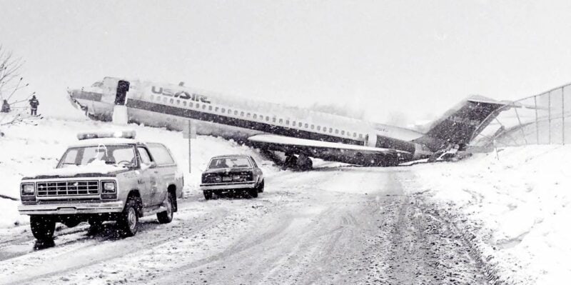 USAir Flight 499 straddling a road in Erie, Pennsylvania, after exiting the runway in a winter storm in 1986