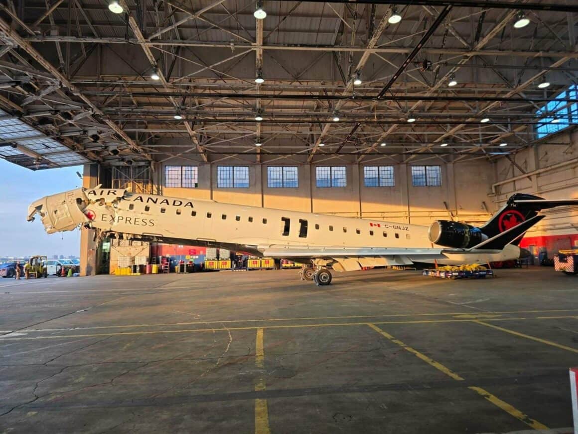 The Air Canada CRJ-900 involved in the fatal LaGuardia runway collision in March 2026 rests in a hangar at LGA