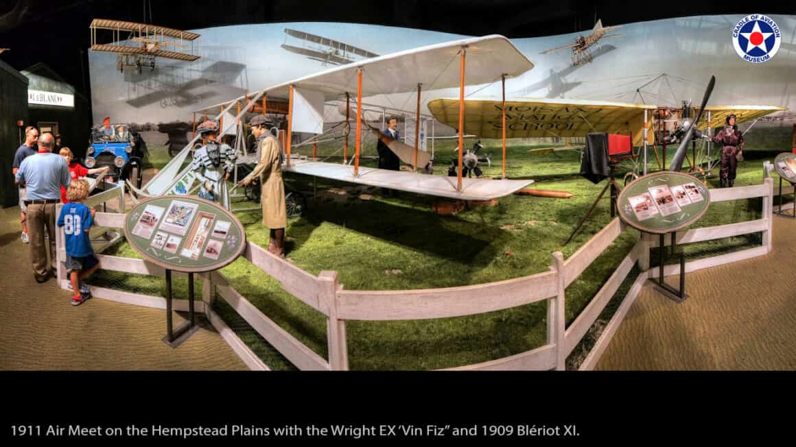 1911, Hempstead Plains. The “Vin Fiz” and a Blériot XI share the field as Cal Rodgers and Harriet Quimby make history.