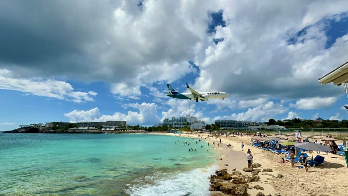 A WestJet Boeing 737 passes over Maho Beach