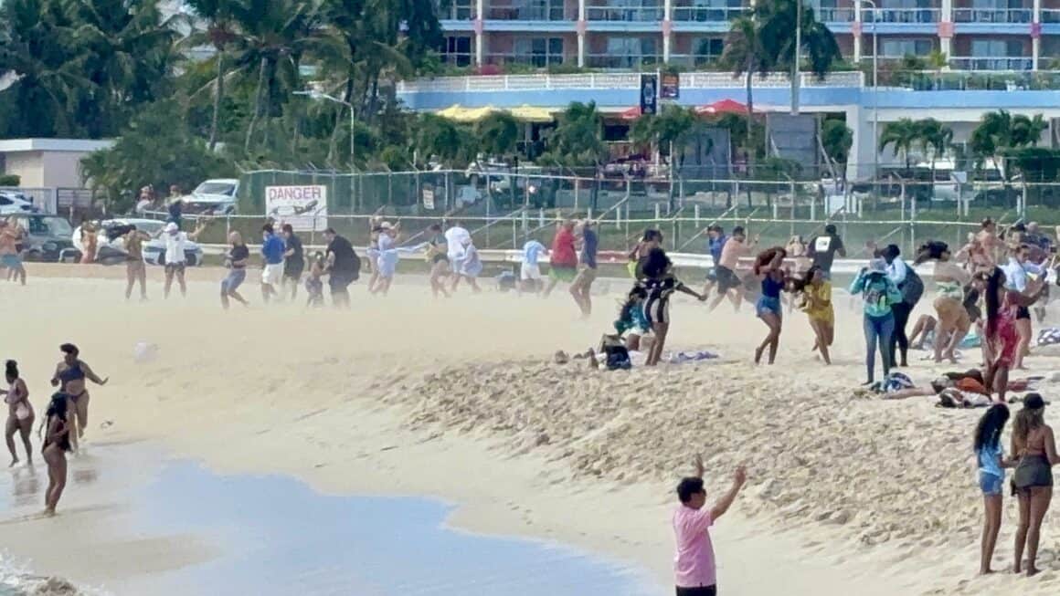 Jet blast blows the sand at Maho Beach