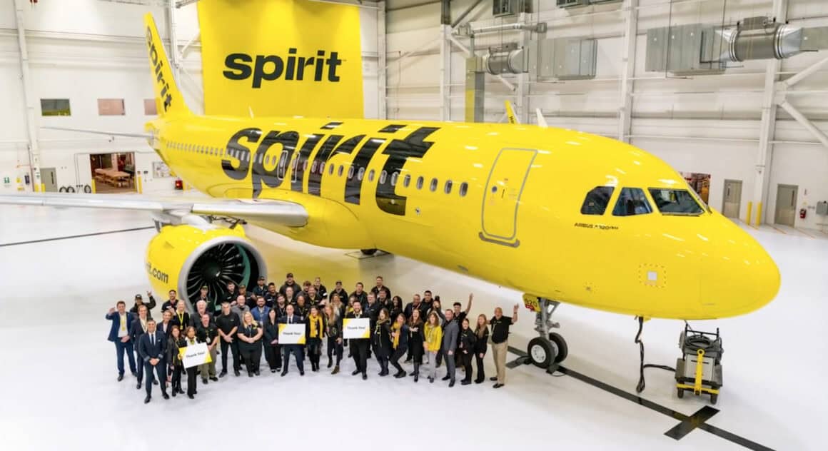 A Spirit Airbus A320neo and a group of employees 