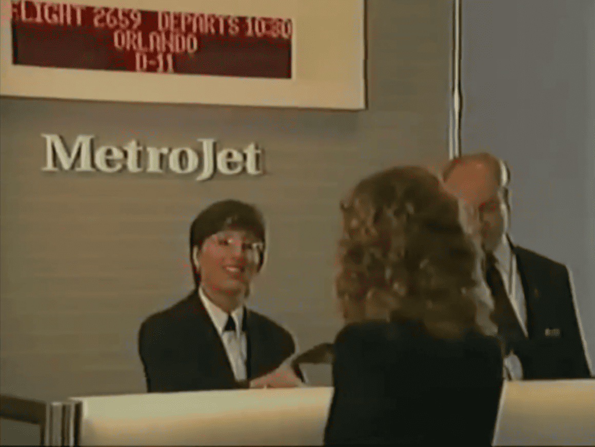 A MetroJet gate agent helps a passenger